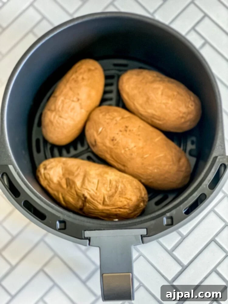 picture of fried potatoes in an air fryer basket