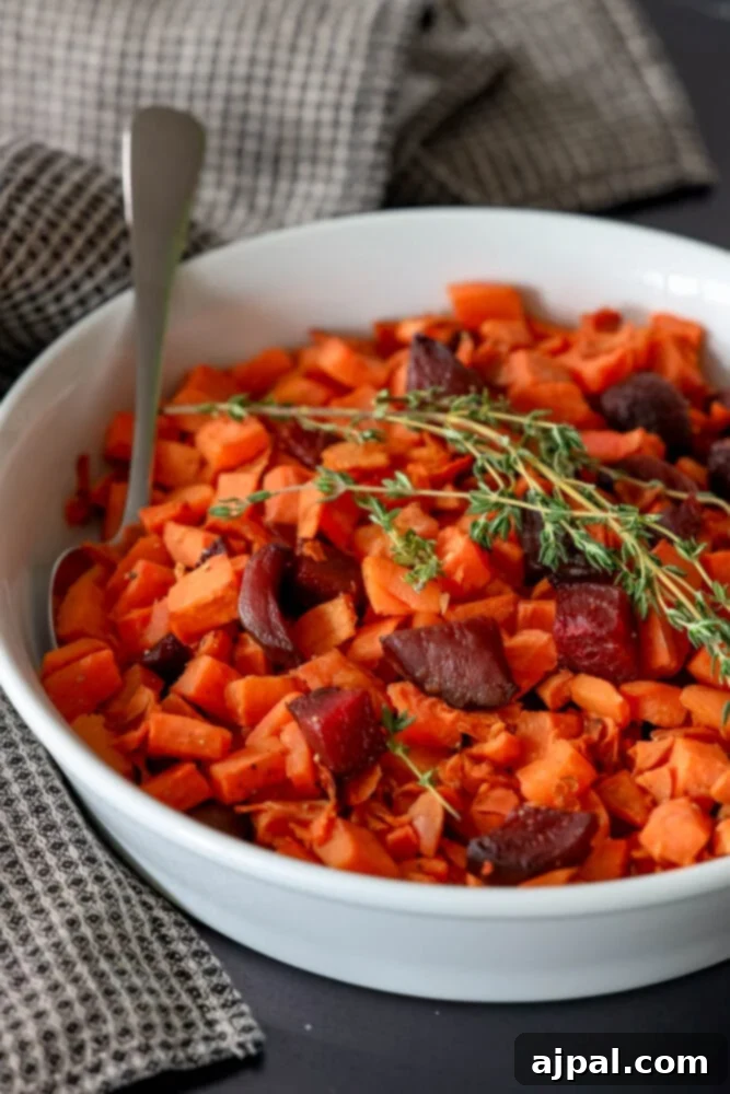 Effortless Roasted Beets & Sweet Potatoes 2 picture of roasted beets and sweet potatoes in a glass dish with thyme on top