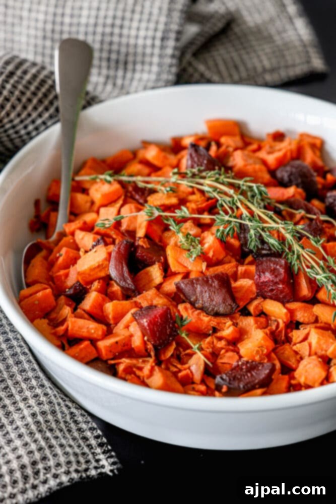 Effortless Roasted Beets & Sweet Potatoes 7 picture of roasted beets and sweet potatoes in a glass dish with thyme on top