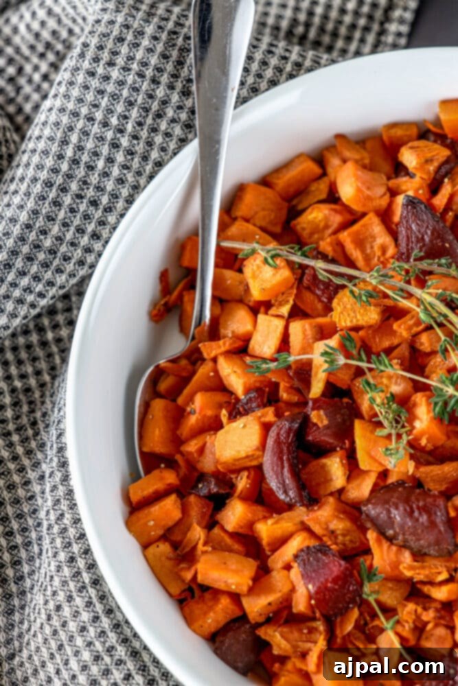 Effortless Roasted Beets & Sweet Potatoes 3 picture of roasted beets and sweet potatoes in a glass dish with thyme on top