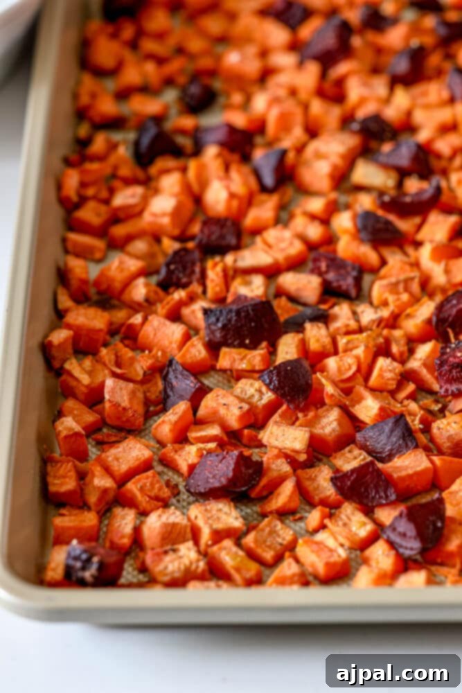 Effortless Roasted Beets & Sweet Potatoes 5 picture of roasted beets and sweet potatoes on a baking sheet