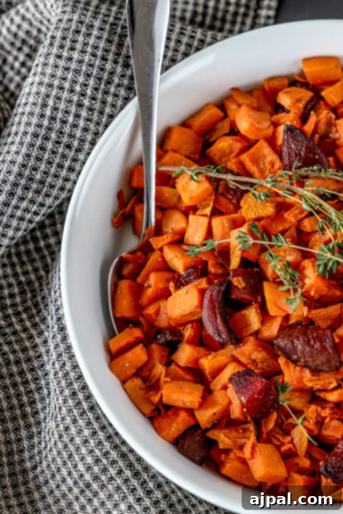 Effortless Roasted Beets & Sweet Potatoes 6 picture of roasted beets and sweet potatoes in a glass dish with thyme on top
