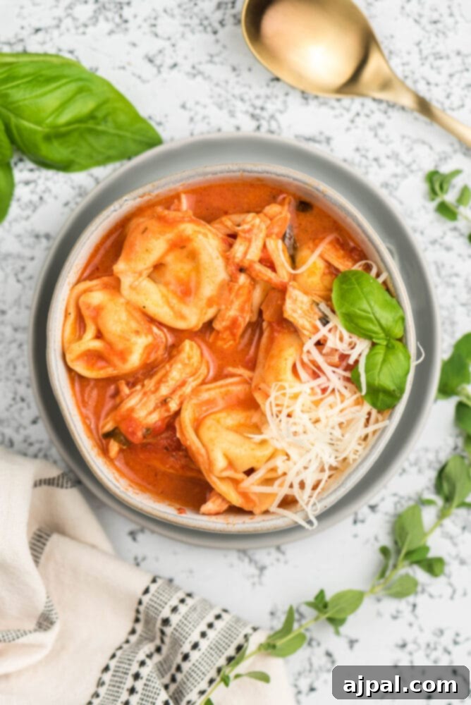 picture of tomato basil chicken tortellini soup in a bowl on a table