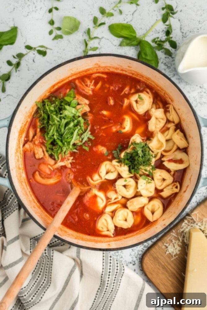Mashing tomatoes in a soup pot