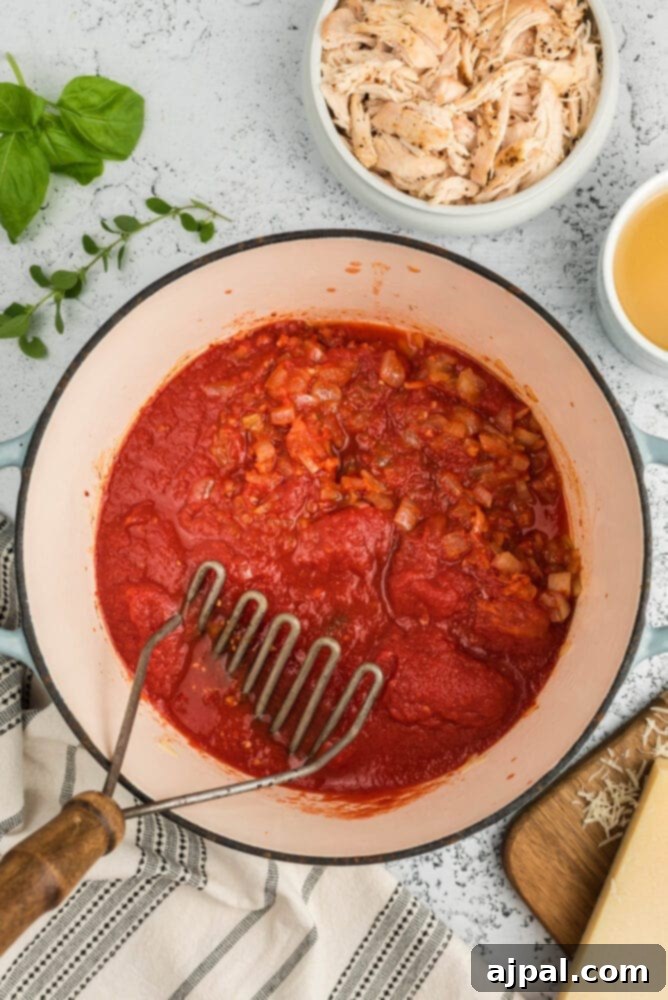 Chopped tomatoes added to the soup pot