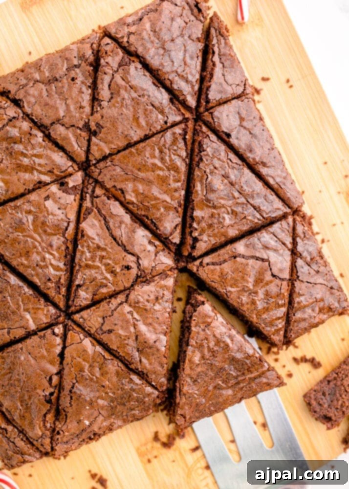 Festive Fudgy Evergreen Brownies 13 A collection of perfectly cut triangle-shaped brownies, resembling small Christmas trees, ready for decoration.