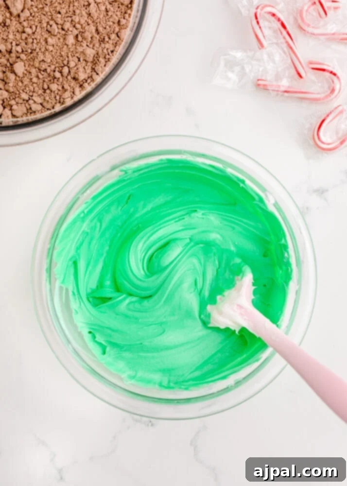 Festive Fudgy Evergreen Brownies 16 Smooth, evenly mixed green frosting in a bowl, perfectly colored and ready for decorating.