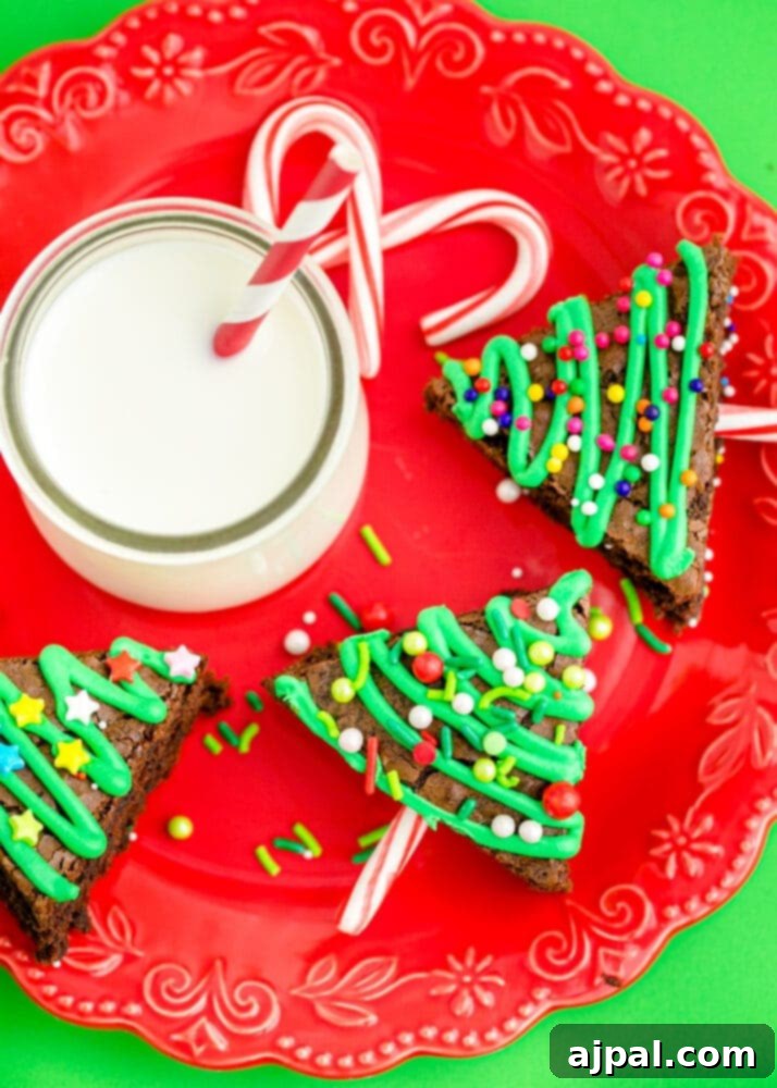 Festive Fudgy Evergreen Brownies 19 A beautifully decorated Christmas tree brownie resting on a vibrant red festive plate.