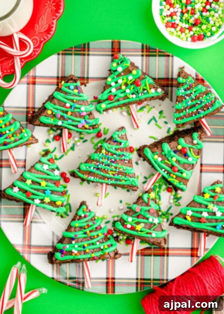 Festive Fudgy Evergreen Brownies 3 A festive plate featuring a meticulously decorated Christmas tree brownie, complete with candy cane trunks.