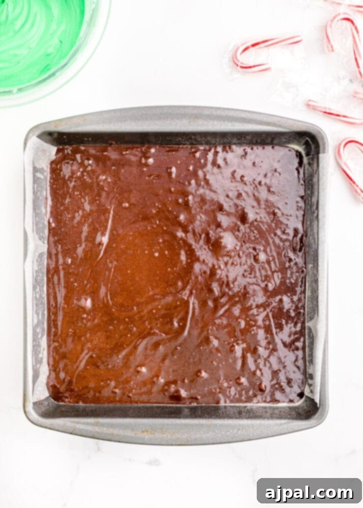 Festive Fudgy Evergreen Brownies 7 Smooth brownie batter evenly spread into a prepared baking pan, ready for the oven.
