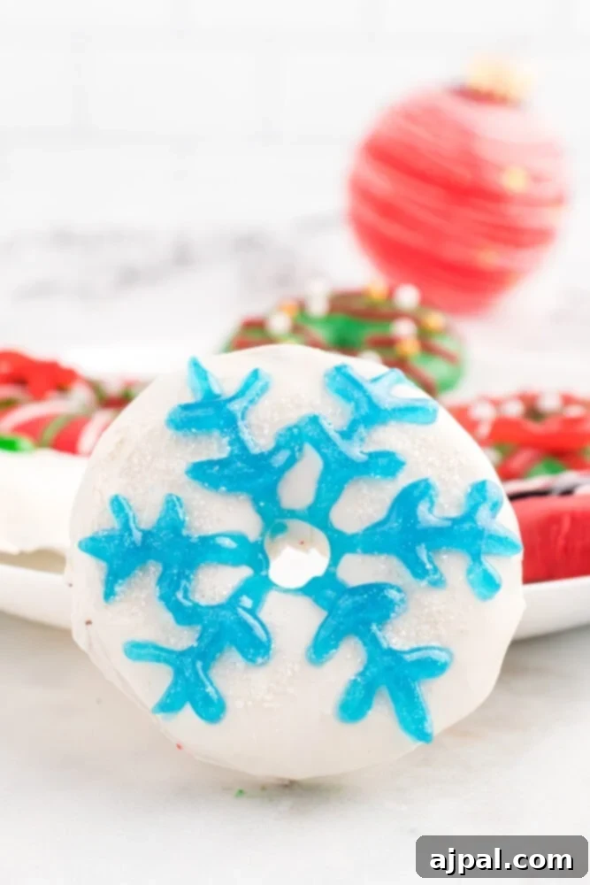 Effortless Christmas Wreath Cookies 17 A pristine white cookie intricately decorated with a delicate icing snowflake, evoking a winter wonderland theme.