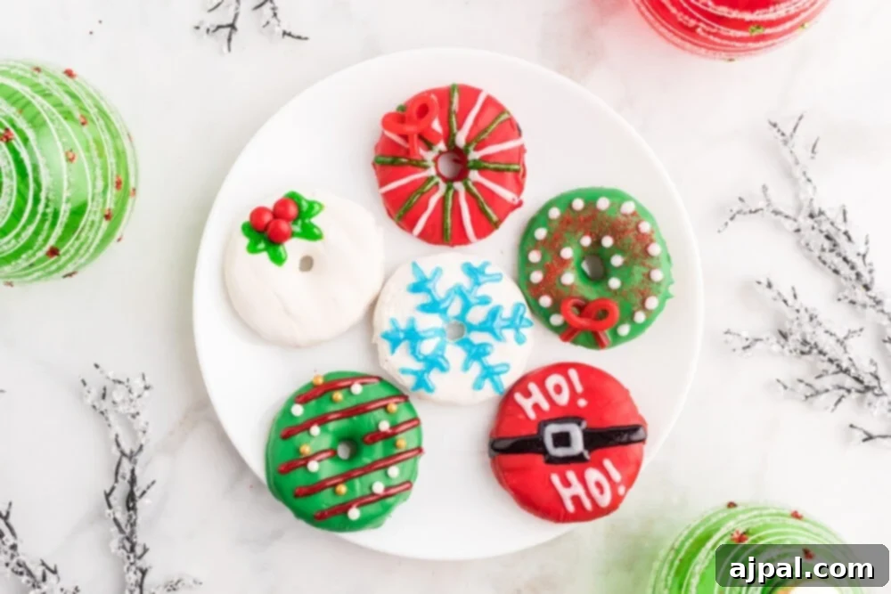 Effortless Christmas Wreath Cookies 3 An assortment of festive Christmas treats, including our easy-to-make dipped Christmas wreath cookies, arranged on a white plate.