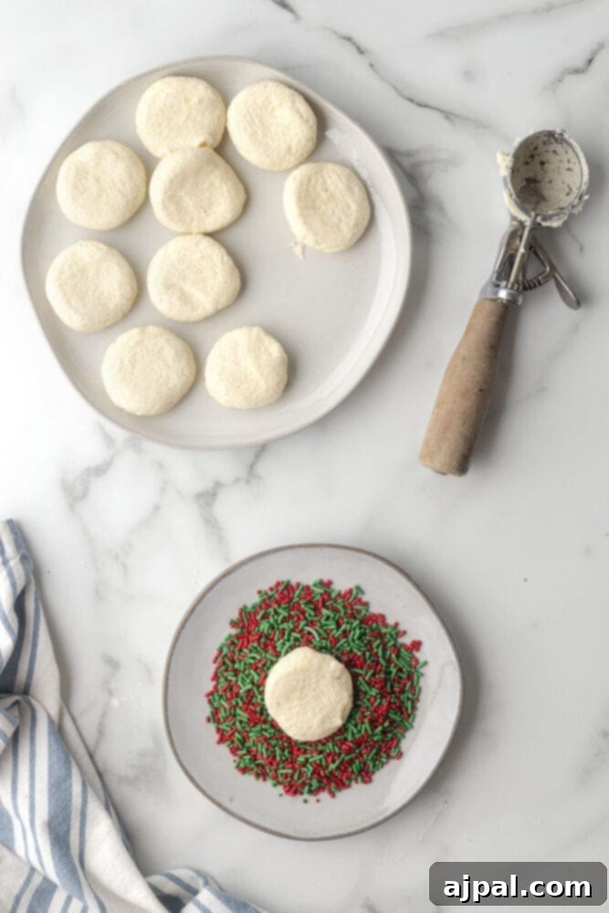 picture of cookies being pressed into sprinkles