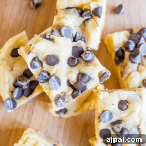 A group of brownies with chocolate chip cookie dough fudge on top.