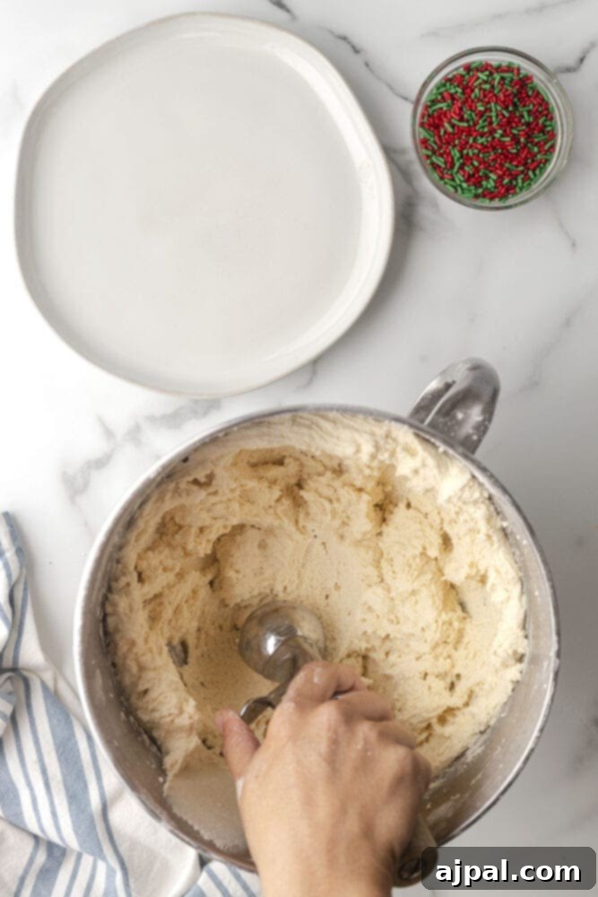 picture of hand scooping cookie dough