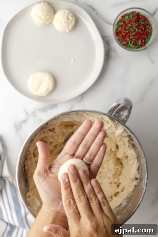 picture of hand rolling cookie dough