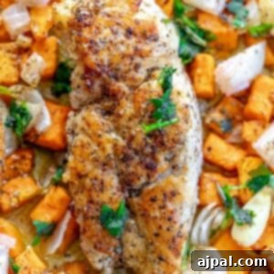 picture of turkey tenderloin on a sheet pan with sweet potatoes and onions