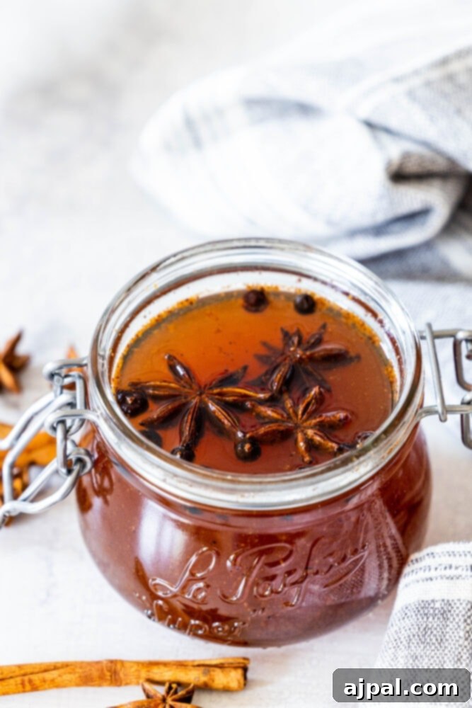 Warming Winter Spice Syrup 2 A jar of honey infused with cinnamon sticks and star anise.