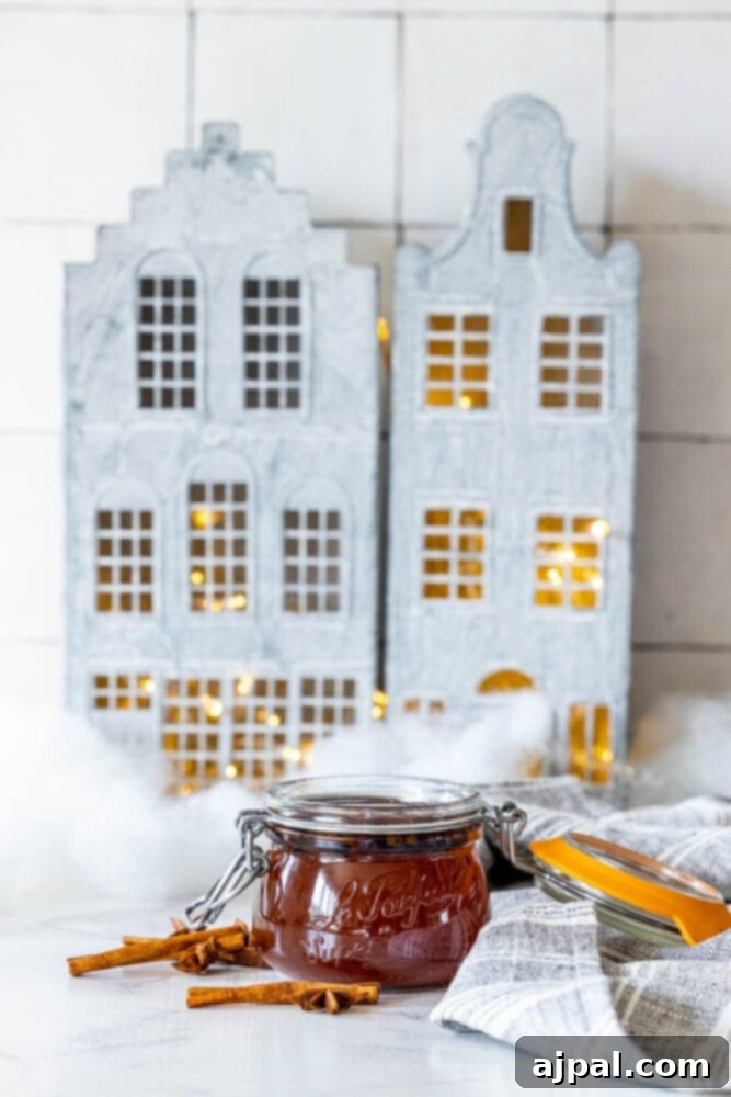 Warming Winter Spice Syrup 3 A jar of cinnamon jam on a table.