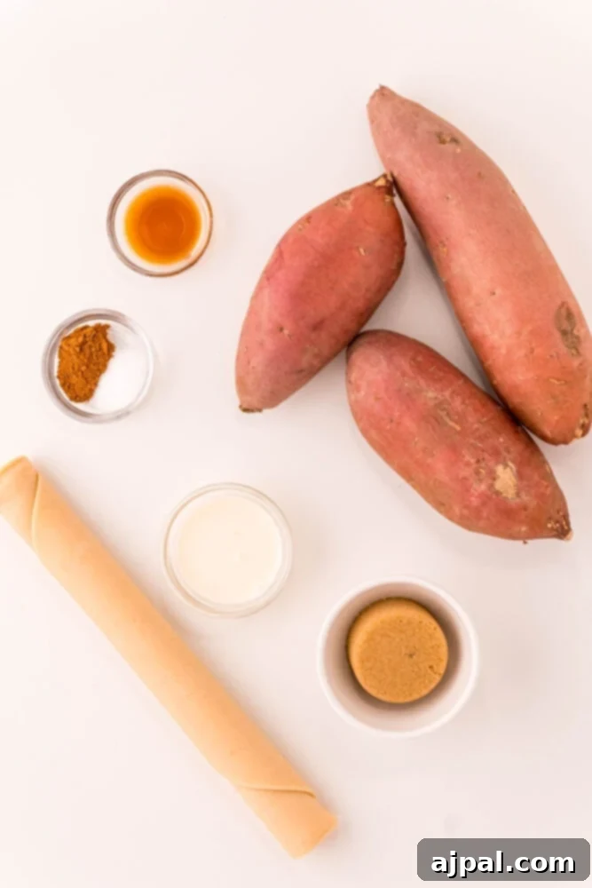 An overhead view of raw sweet potatoes, granulated sugar, aromatic herbs, and ready-made pie crust on a wooden surface, highlighting the fresh ingredients for baking.