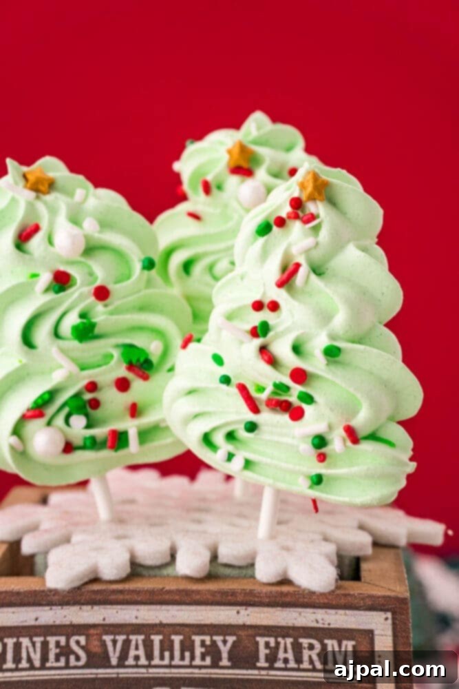 picture of meringue christmas tree cookie pops on a wooden box