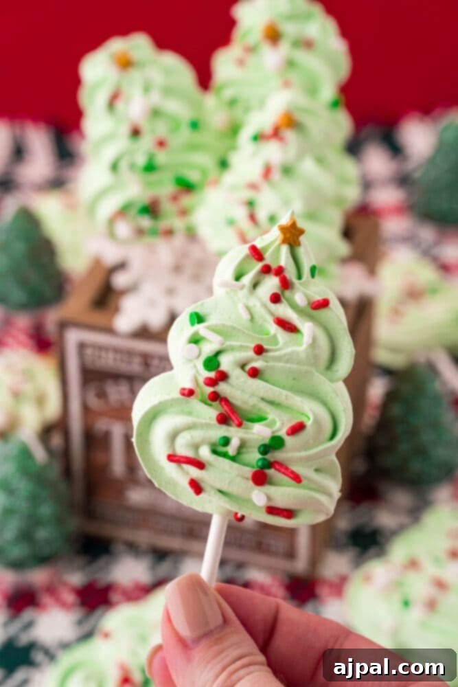 picture of meringue christmas tree cookie pops on a wooden box