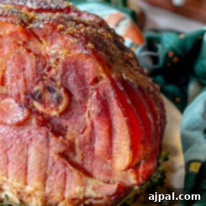 A homemade Honey Baked Ham is sitting on top of a plate.