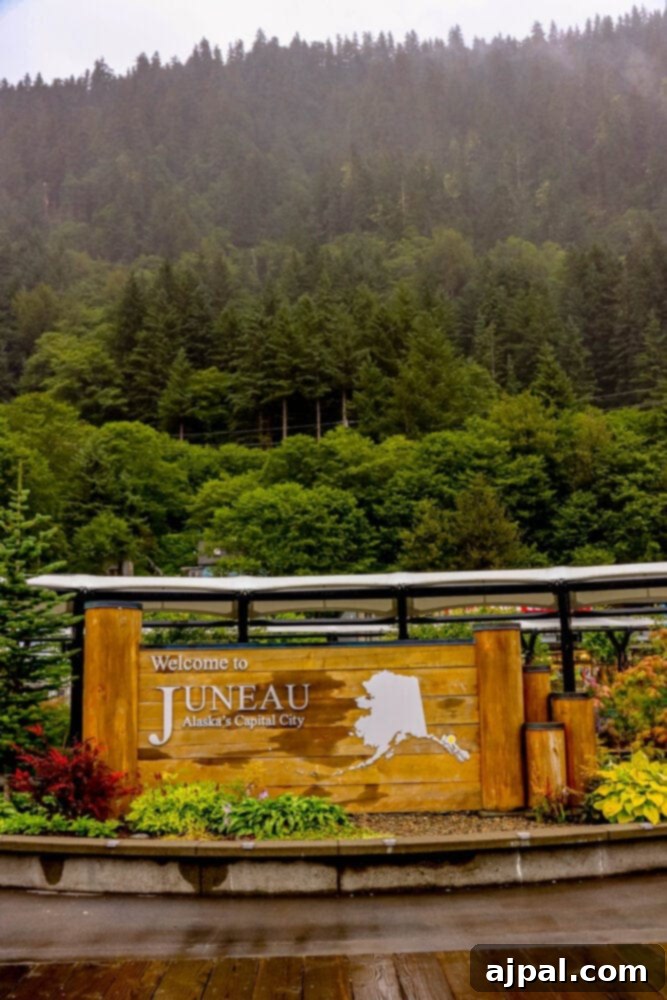 A wooden sign welcoming visitors to Juneau, Alaska, nestled amidst the pristine natural beauty of the Last Frontier.