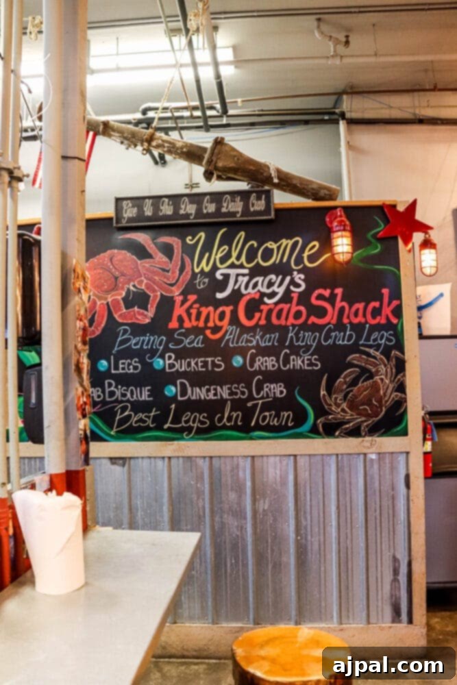 A vibrant menu board inside Tracy's King Crab Shack in Juneau, Alaska, showcasing their fresh seafood offerings and local specialties.