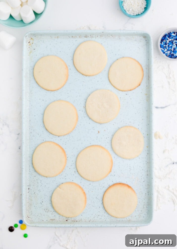 Snowman Meltdown Cookies 12 picture of baked cookies on a baking sheet, golden brown and perfectly cooked