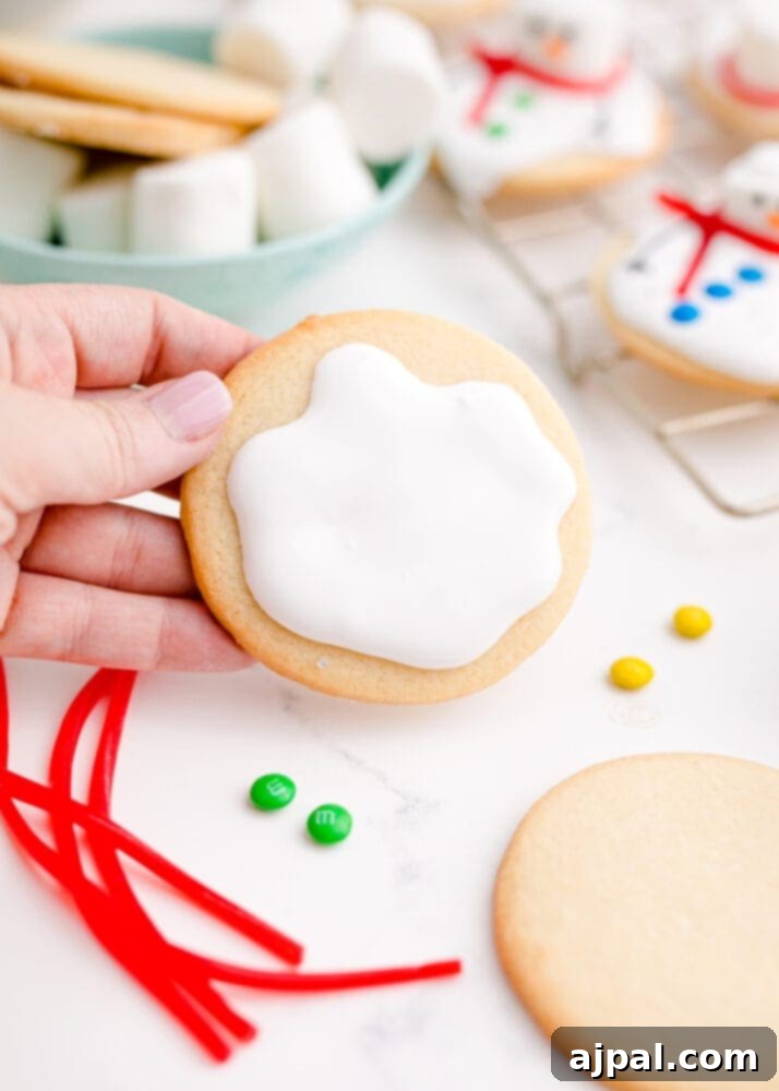 Snowman Meltdown Cookies 19 picture of icing on a cookie, spread to create an irregular, melted snow effect