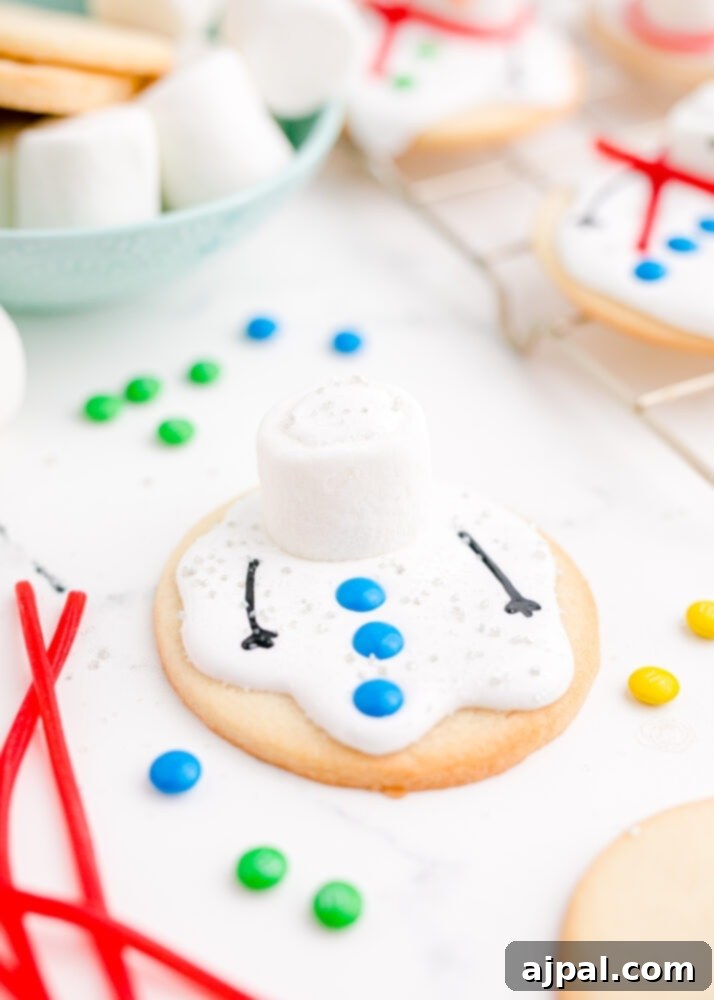 Snowman Meltdown Cookies 23 picture of cookie with candy on it, showing the early stages of snowman decoration