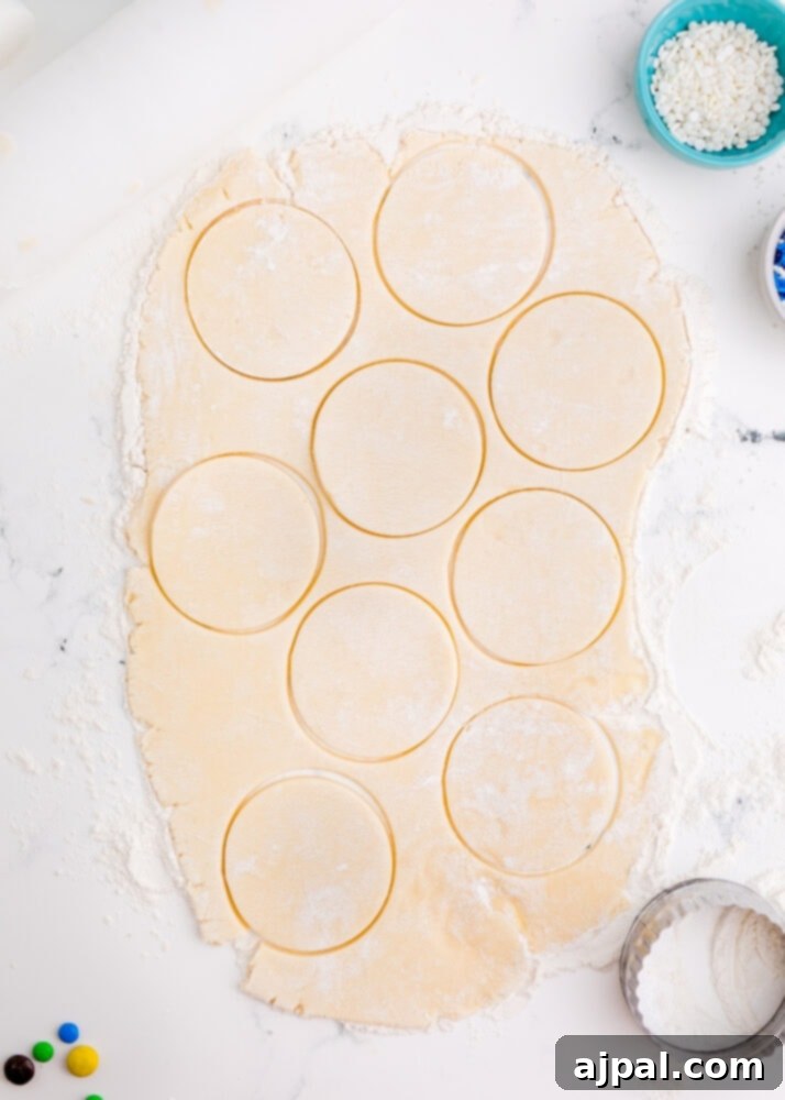 Snowman Meltdown Cookies 10 picture of circles cut into cookie dough on a table, perfectly shaped for baking