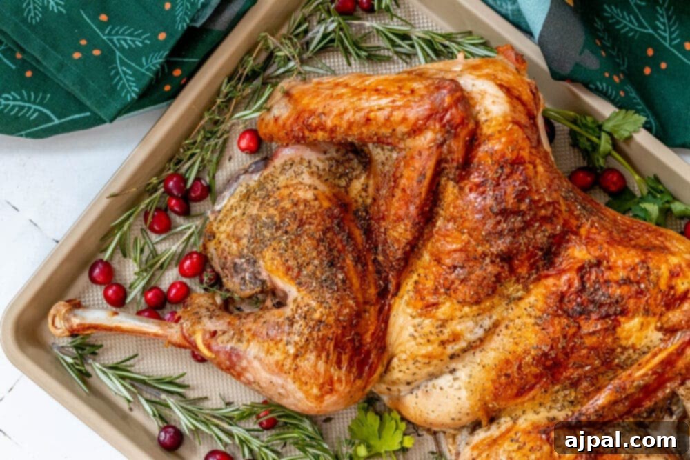 picture of a spatchcocked baked turkey on a baking sheet