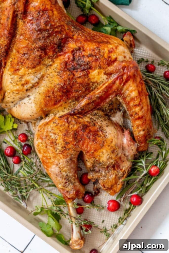picture of a spatchcocked baked turkey on a baking sheet