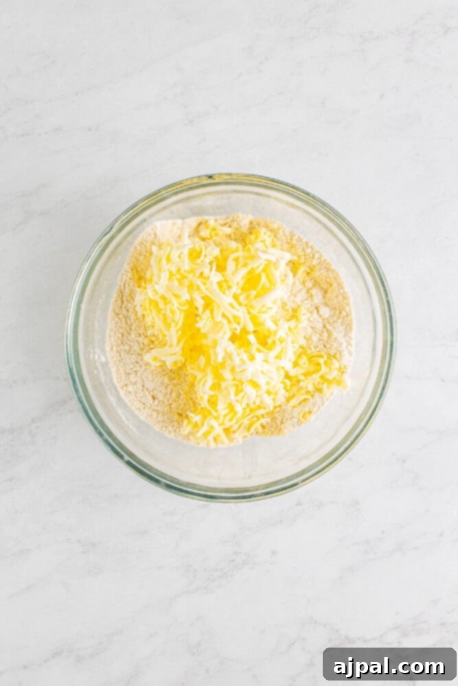 The buttermilk and dry ingredients partially mixed in a bowl, forming a shaggy dough.