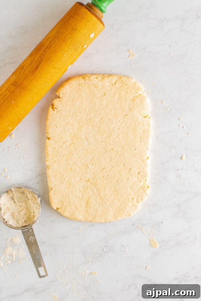 Biscuit dough rolled out into a rectangle on a lightly floured work surface.