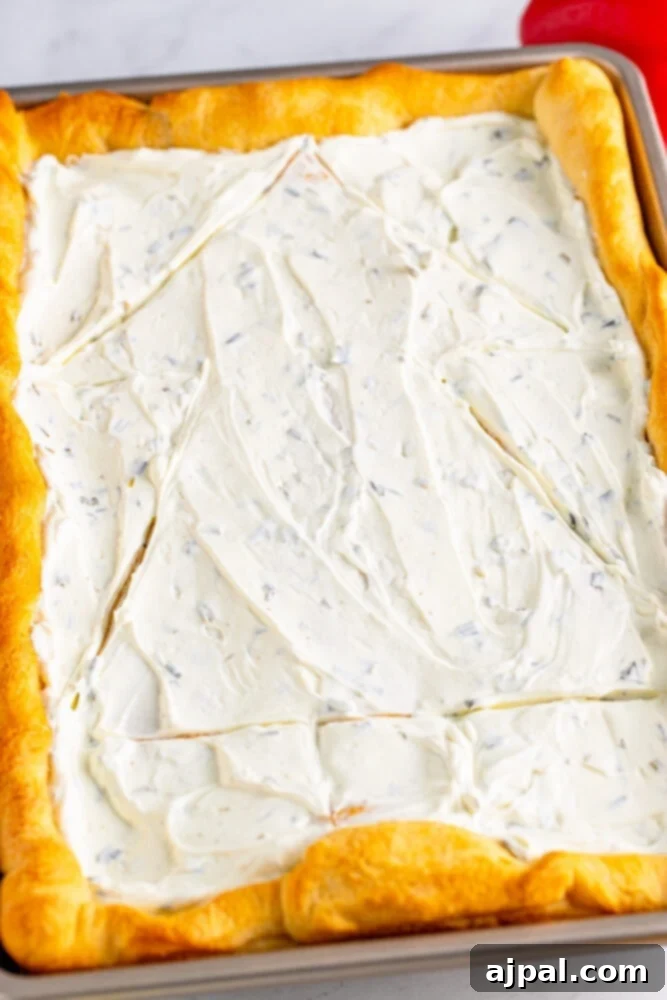 The clear outline of a Christmas tree is visible in the cream cheese, ready to be filled with vibrant vegetables.