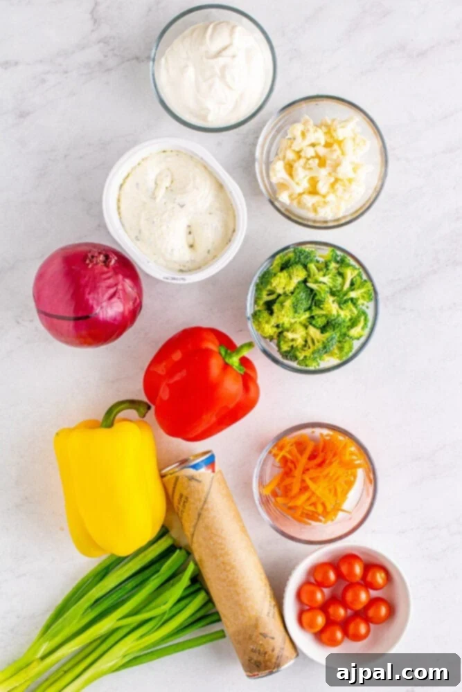 A collection of fresh ingredients laid out, including vibrant broccoli, cauliflower, carrots, bell peppers, and sour cream, essential for making the veggie pizza.