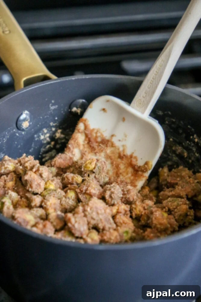 picture of pistachios being stirred into candy mixture