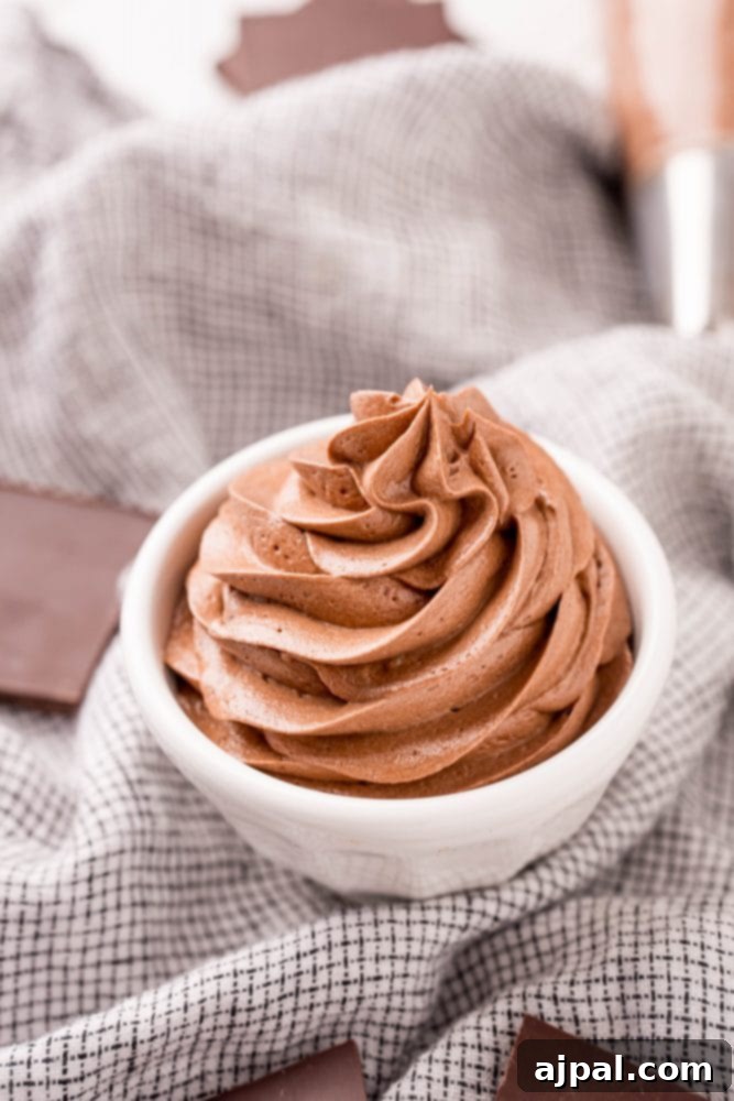 Decadent chocolate pudding frosting in a white bowl, ready for spreading