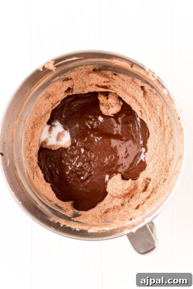 Melted chocolate being incorporated into the butter and pudding mixture