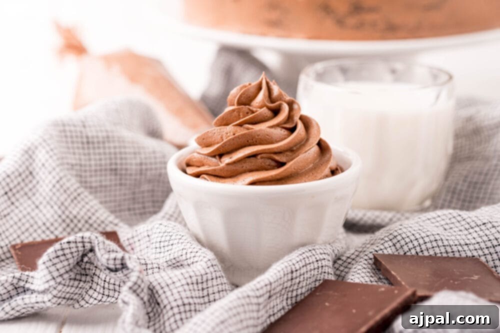 Homemade chocolate pudding frosting adorned with chocolate shavings in a pristine white bowl