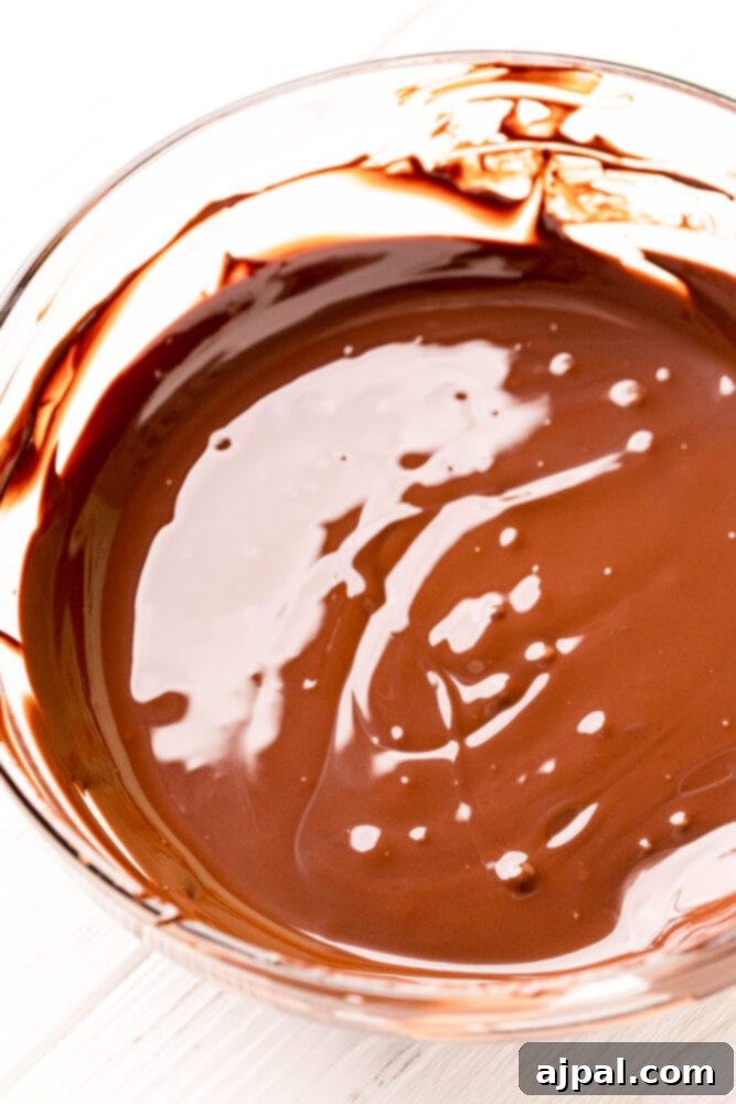 Rich, melted chocolate in a small bowl, cooling