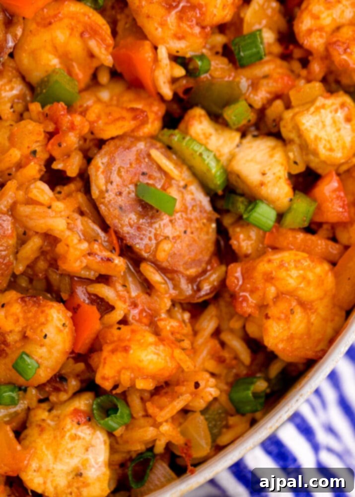 picture of jambalaya with shrimp, sausage, and chicken in a pan on a table