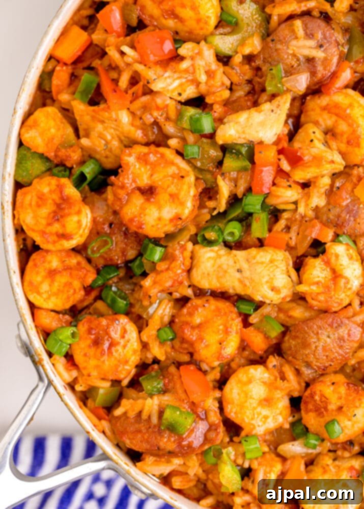 picture of jambalaya with shrimp, sausage, and chicken in a pan on a table
