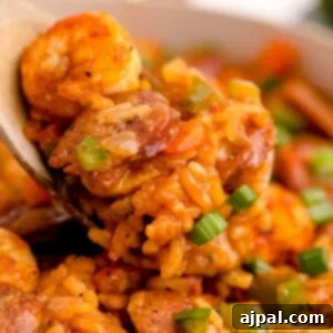 picture of jambalaya with shrimp, sausage, and chicken in a pan on a table