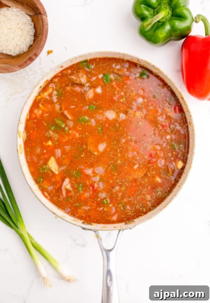 picture of jambalaya with rice cooking in a pan