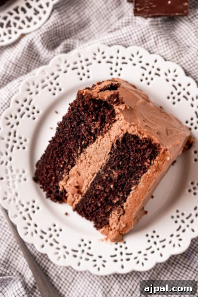 Decadent Chocolate Perfection 4 A three-layer chocolate cake with generous frosting, ready for slicing on a white cake stand.