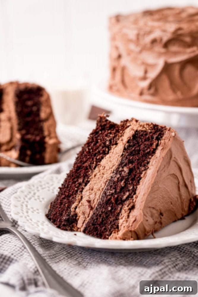 Decadent Chocolate Perfection 5 A perfect slice of homemade chocolate cake with creamy frosting on a white plate, ready to be enjoyed.